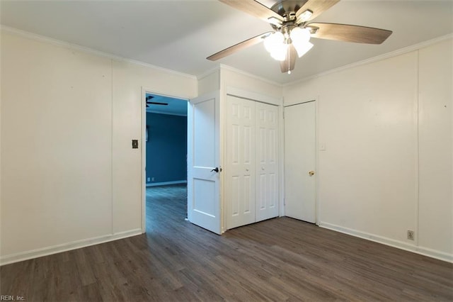 unfurnished bedroom with a closet, ceiling fan, crown molding, and dark wood-type flooring