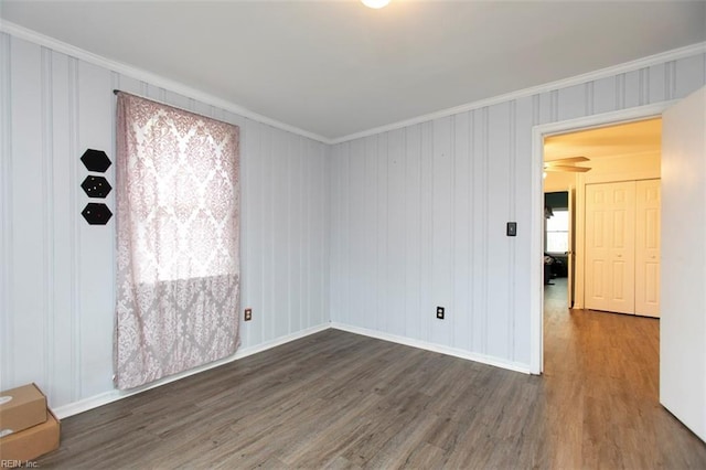 spare room featuring dark hardwood / wood-style floors and ornamental molding