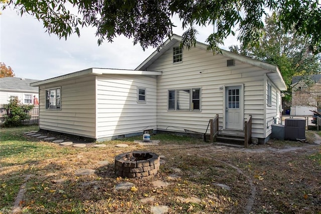 back of house featuring a fire pit