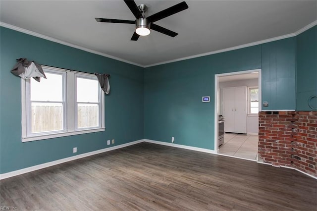 spare room featuring ceiling fan, ornamental molding, and light hardwood / wood-style flooring