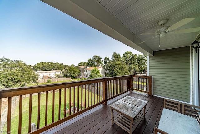 deck featuring ceiling fan and a lawn