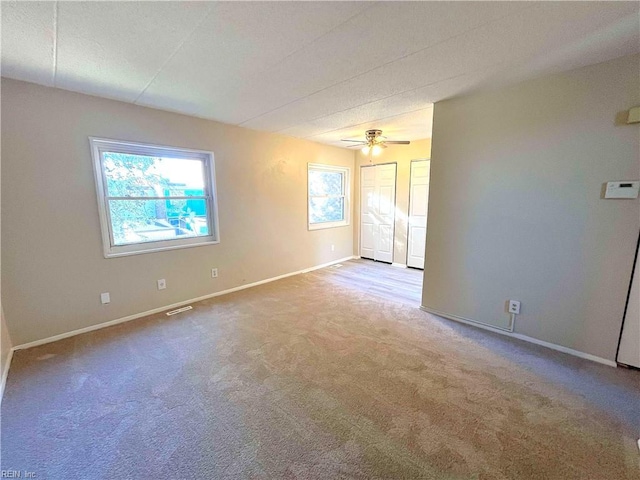 carpeted empty room with ceiling fan