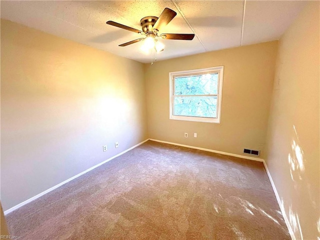 empty room featuring ceiling fan and carpet floors