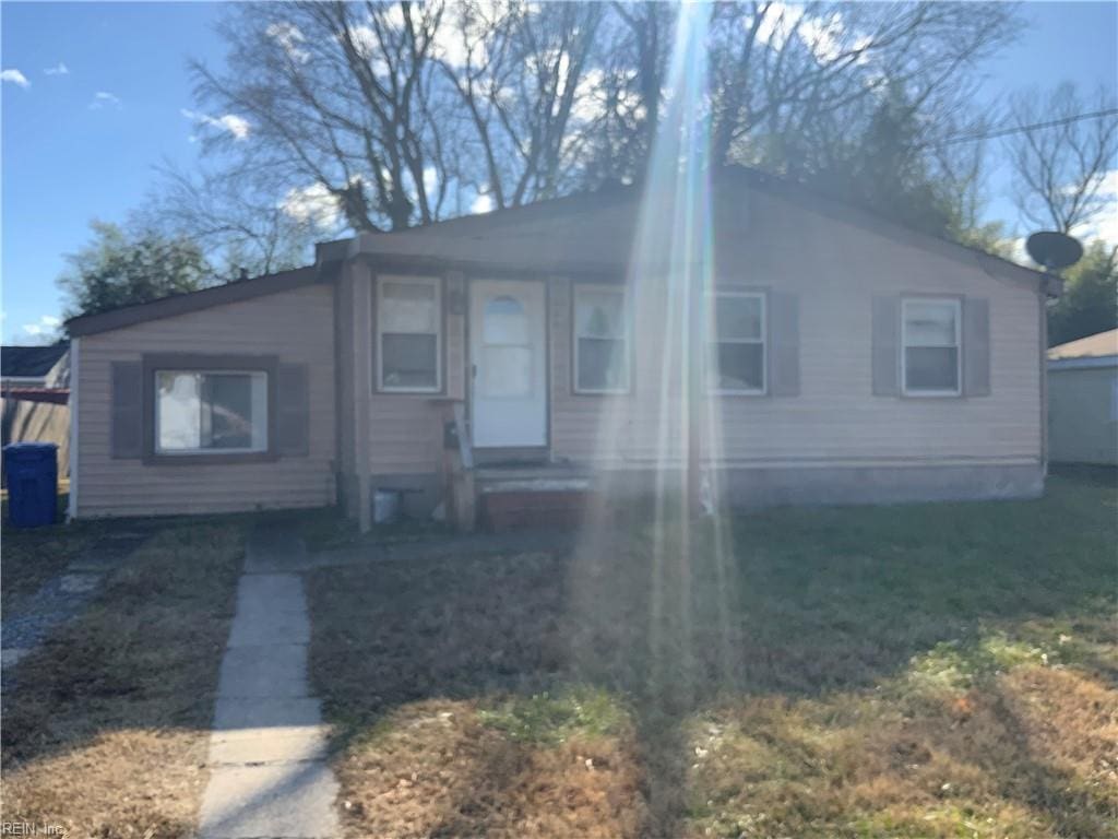 bungalow-style home with a front lawn