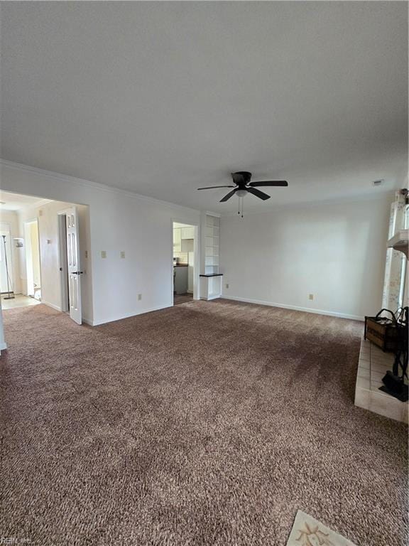 unfurnished living room featuring ceiling fan, carpet floors, and ornamental molding