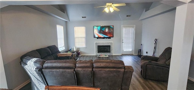 living room with hardwood / wood-style flooring, ceiling fan, lofted ceiling, and a fireplace