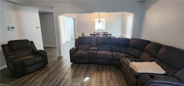 living room with a notable chandelier and dark wood-type flooring