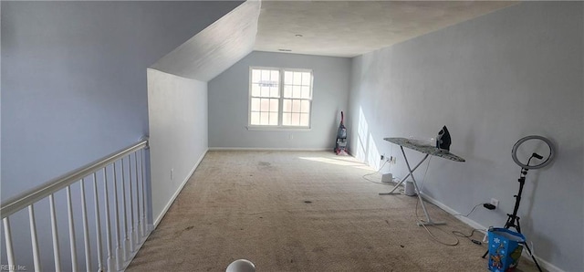 additional living space with light carpet and vaulted ceiling