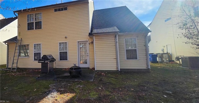 back of property featuring a lawn and cooling unit