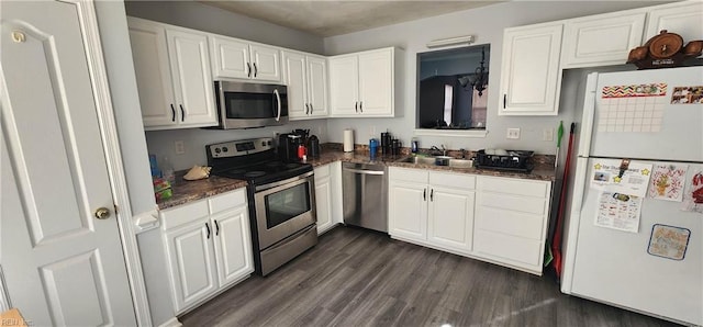 kitchen with dark hardwood / wood-style flooring, white cabinetry, sink, and appliances with stainless steel finishes