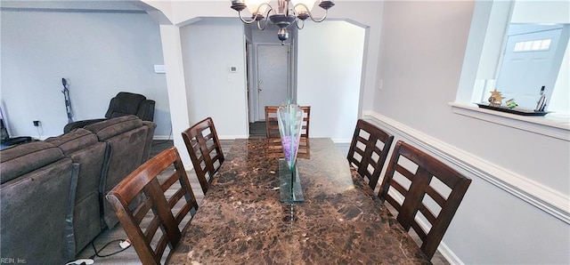 dining area featuring a notable chandelier