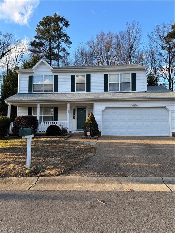 view of property featuring covered porch and a garage