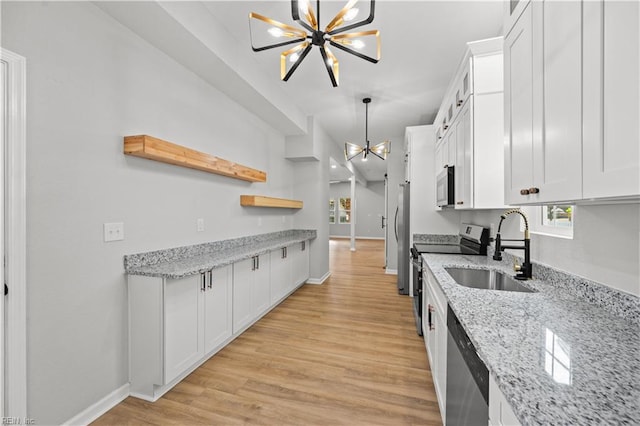 kitchen with white cabinets, a notable chandelier, sink, and appliances with stainless steel finishes