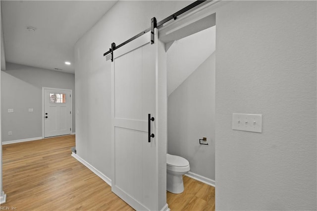 bathroom with wood-type flooring and toilet