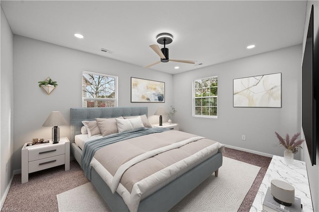 carpeted bedroom with multiple windows and ceiling fan