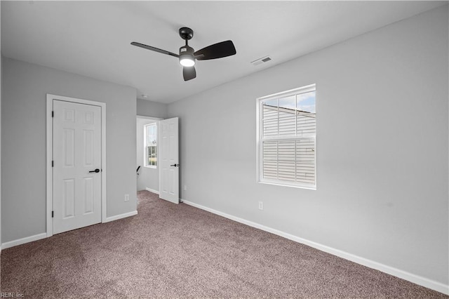 unfurnished bedroom featuring carpet and ceiling fan