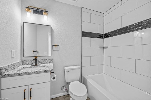 full bathroom featuring tiled shower / bath, vanity, and toilet