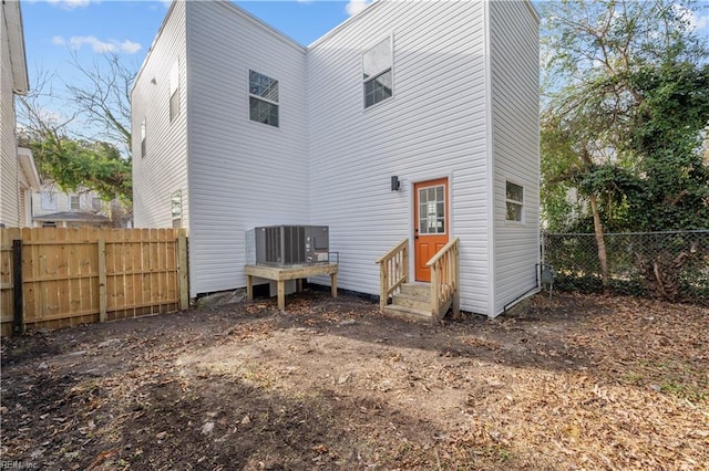 rear view of property with cooling unit