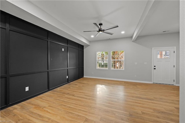 unfurnished living room with ceiling fan and light hardwood / wood-style flooring