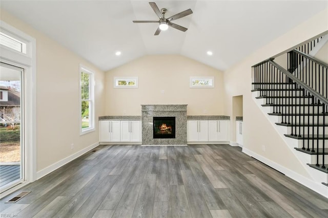 unfurnished living room with ceiling fan, dark hardwood / wood-style flooring, and vaulted ceiling