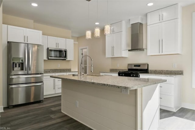 kitchen featuring appliances with stainless steel finishes, white cabinetry, and wall chimney exhaust hood