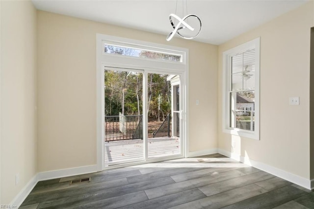 entryway featuring dark hardwood / wood-style floors and a notable chandelier