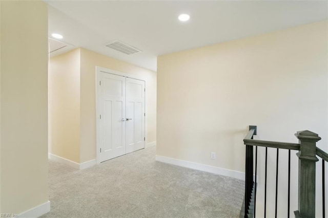 unfurnished room with light colored carpet