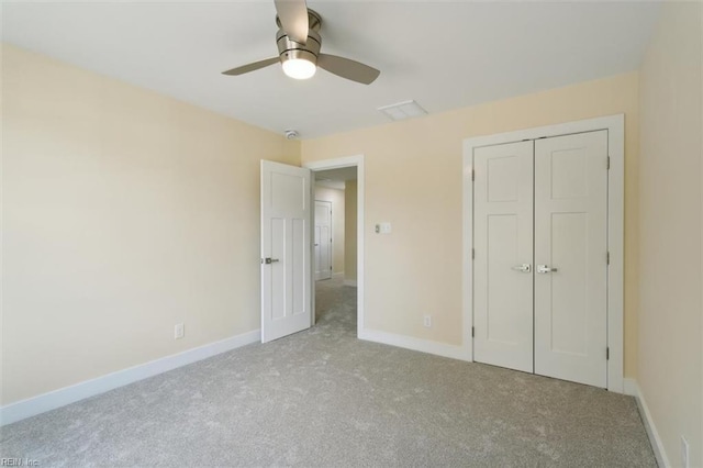 unfurnished bedroom with a closet, ceiling fan, and light colored carpet