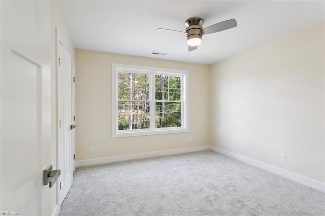 unfurnished room with ceiling fan and light colored carpet