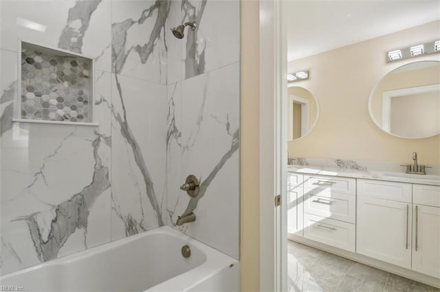 bathroom featuring vanity and tiled shower / bath