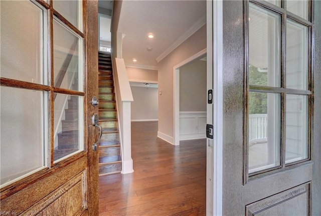 foyer with dark hardwood / wood-style flooring and ornamental molding