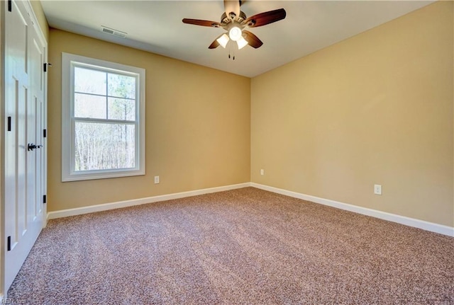 spare room with carpet flooring and ceiling fan