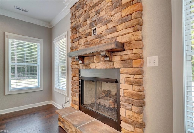 interior details with a fireplace, hardwood / wood-style floors, and ornamental molding