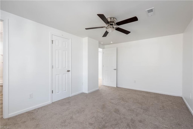 unfurnished room featuring light carpet and ceiling fan