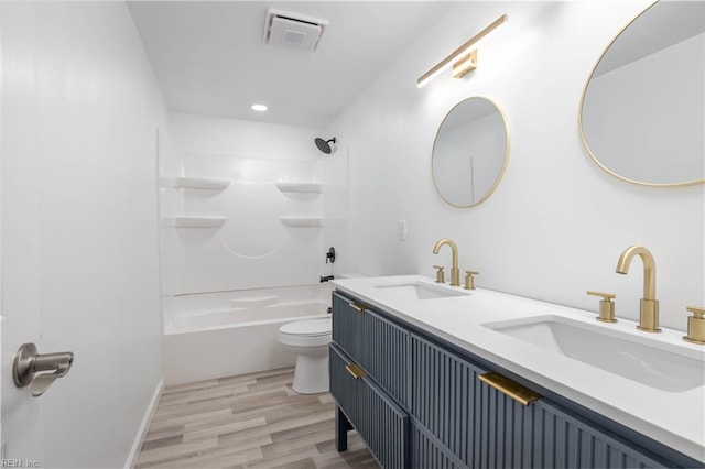 full bathroom featuring vanity,  shower combination, toilet, and wood-type flooring