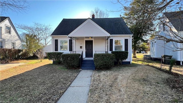 bungalow-style house with a front yard and a porch