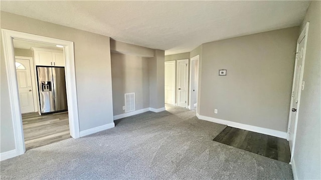 spare room with light colored carpet