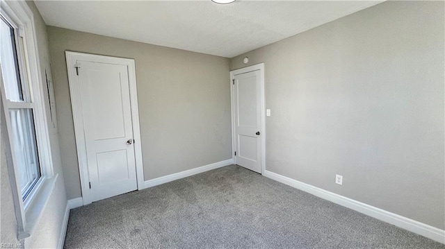 carpeted empty room with a wealth of natural light