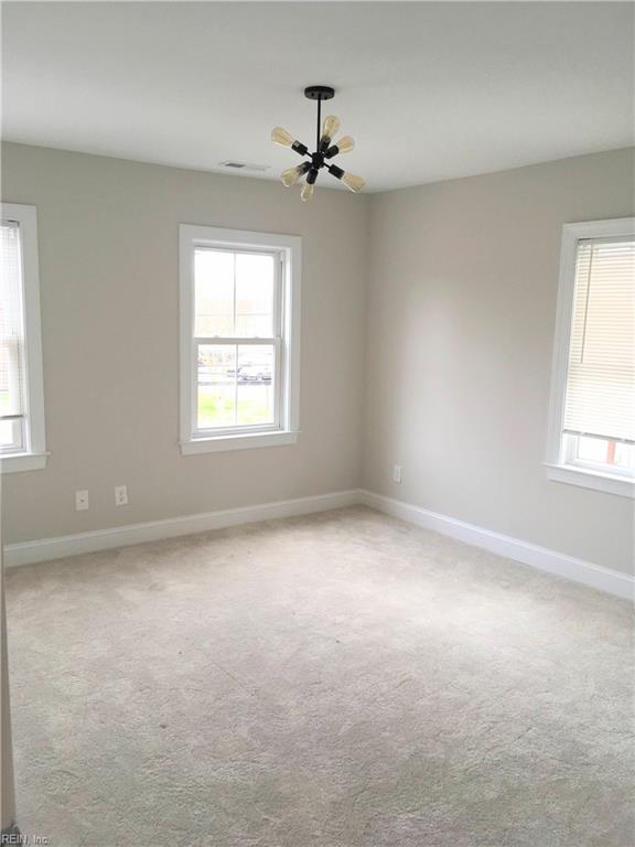 carpeted spare room with a wealth of natural light