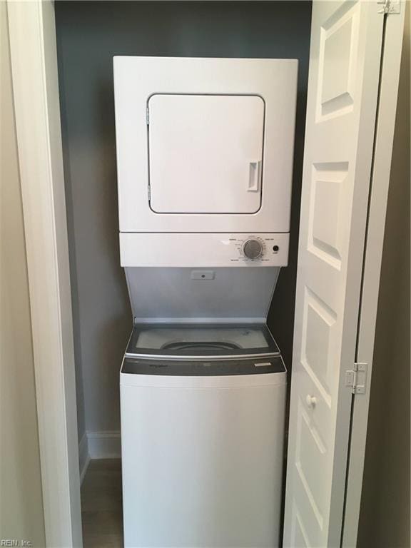 clothes washing area featuring stacked washer / drying machine