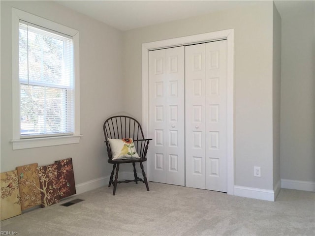 living area with light carpet