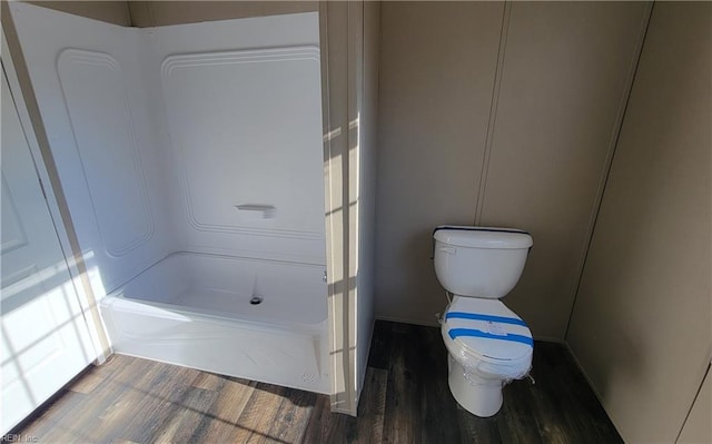 bathroom featuring shower / bath combination, toilet, and wood-type flooring