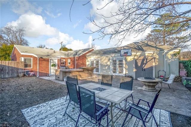 back of house featuring a fire pit and a patio area