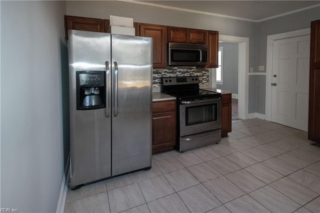 kitchen featuring tasteful backsplash, light tile patterned floors, ornamental molding, and appliances with stainless steel finishes