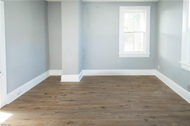 spare room featuring dark wood-type flooring