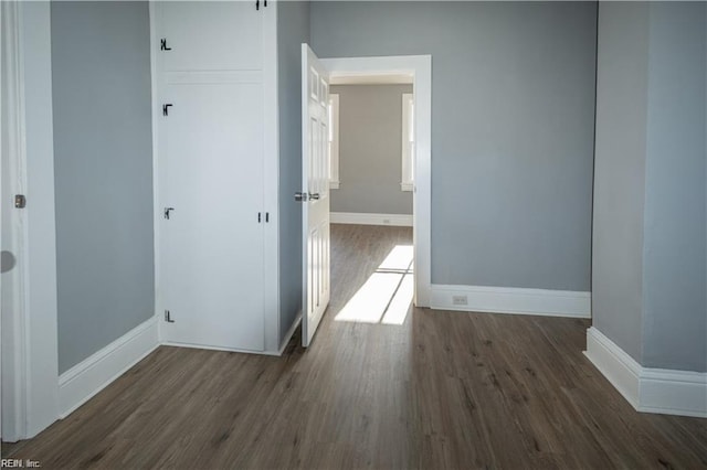 empty room with dark hardwood / wood-style flooring