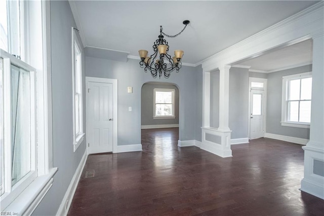 interior space featuring decorative columns, a wealth of natural light, and ornamental molding