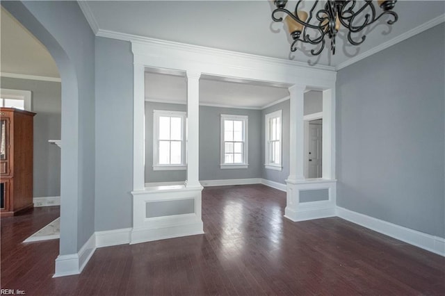 unfurnished living room featuring a chandelier, dark hardwood / wood-style flooring, and ornamental molding