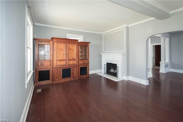 unfurnished living room featuring dark hardwood / wood-style floors, beam ceiling, and crown molding