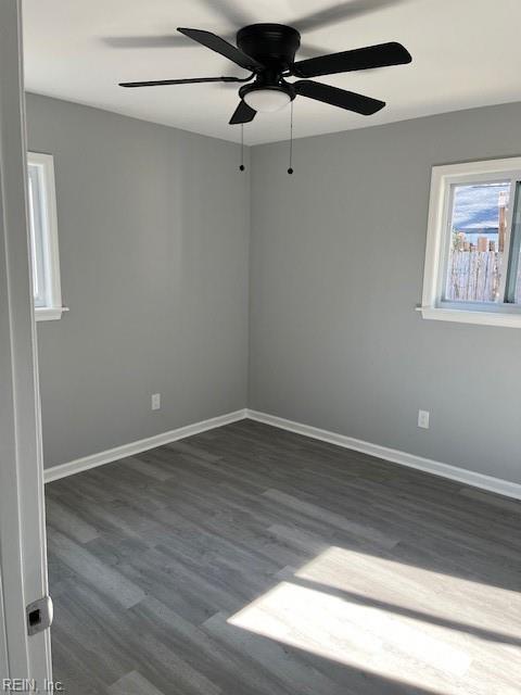 unfurnished room with dark hardwood / wood-style flooring and ceiling fan